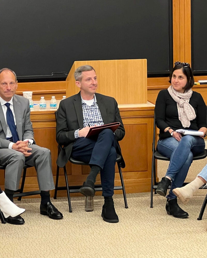 Panelists including Scott Westfahl, Michael Gregory, and Sabrineh Ardalan sit at the front of a classroom.