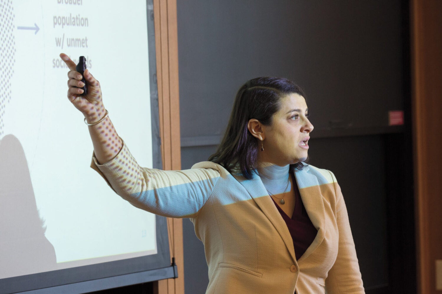 A woman pointing to something on a whiteboard