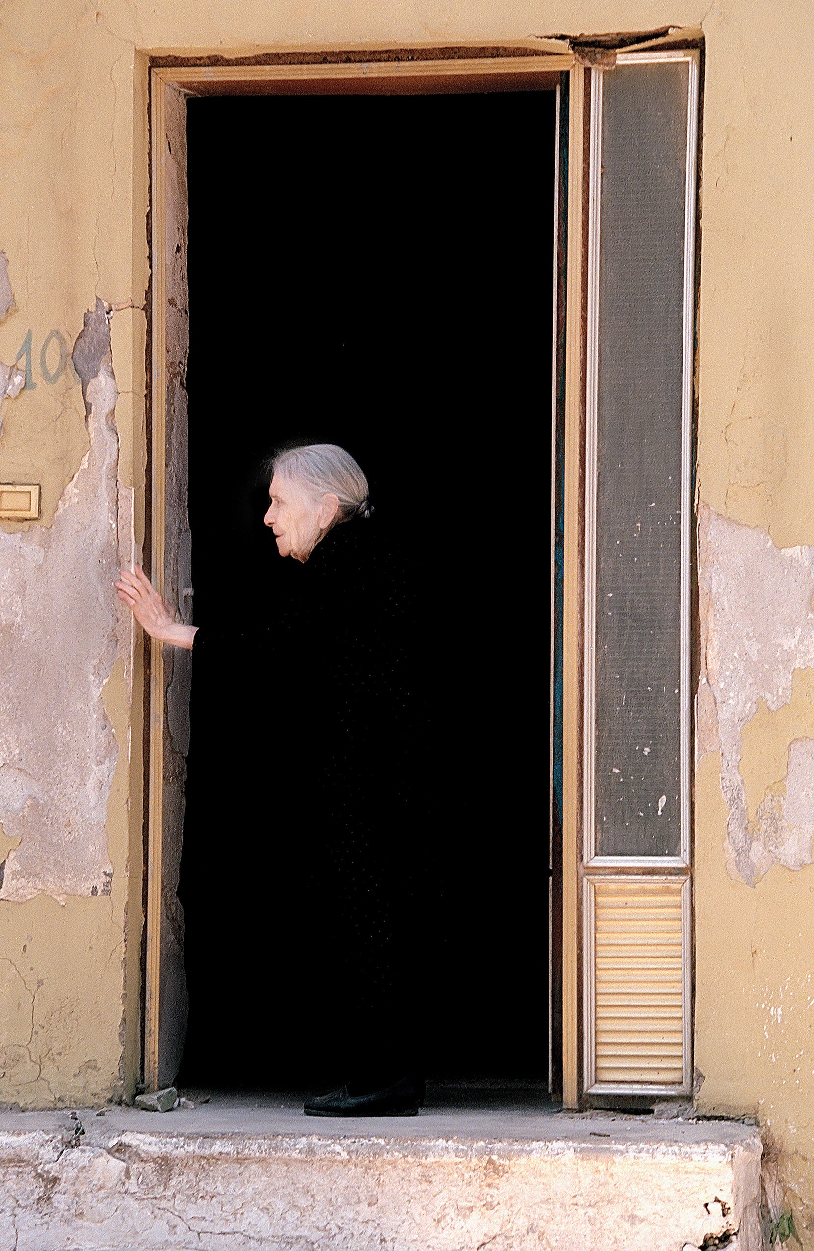 A woman in a black dress in a doorway