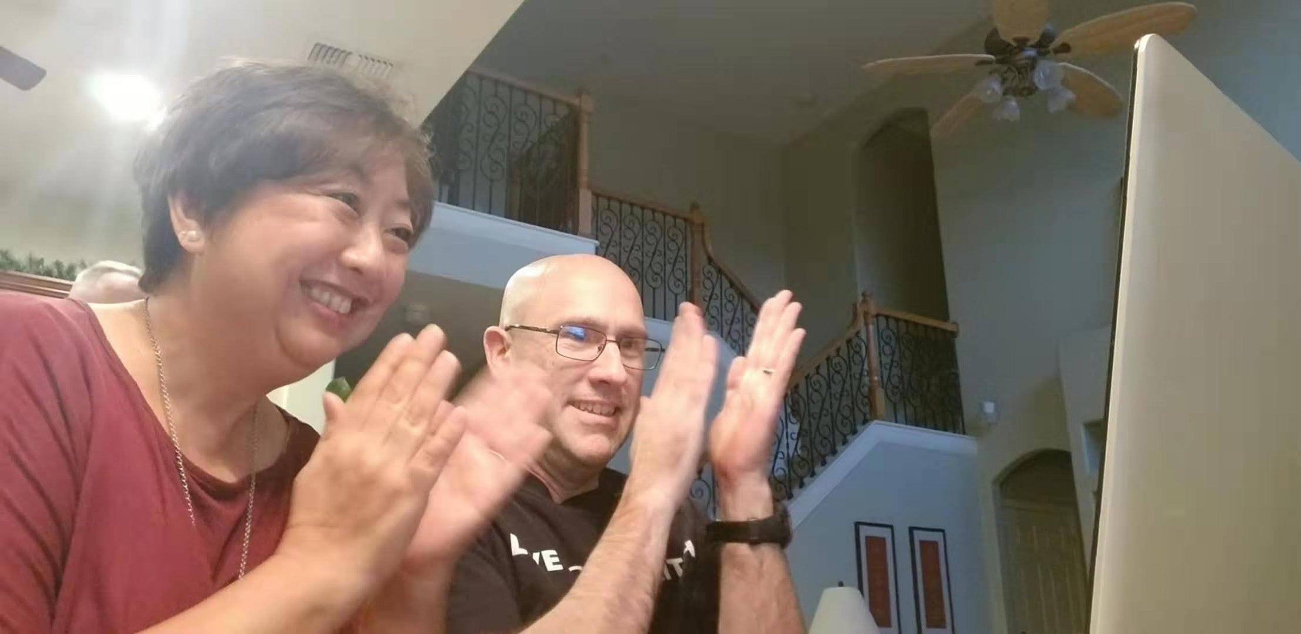 Parents clapping as they watch the 2021 Ames Finals on Zoom