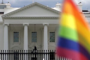 A rainbow flag flying outside of the White House.
