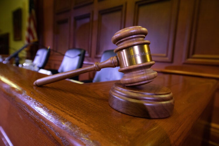 Close up of a gavel sitting on the bench in a courtroom
