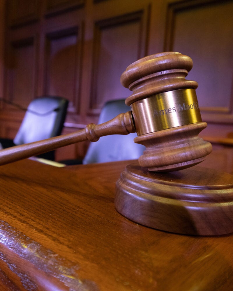 Close up of a gavel sitting on the bench in a courtroom