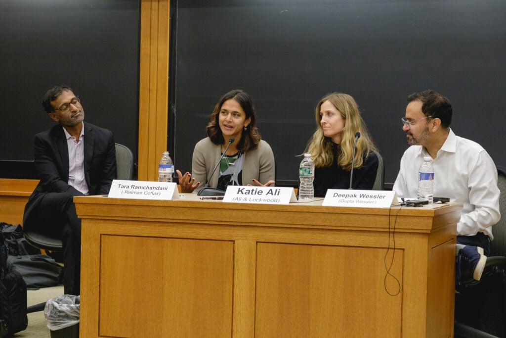 Panelists sit in a line