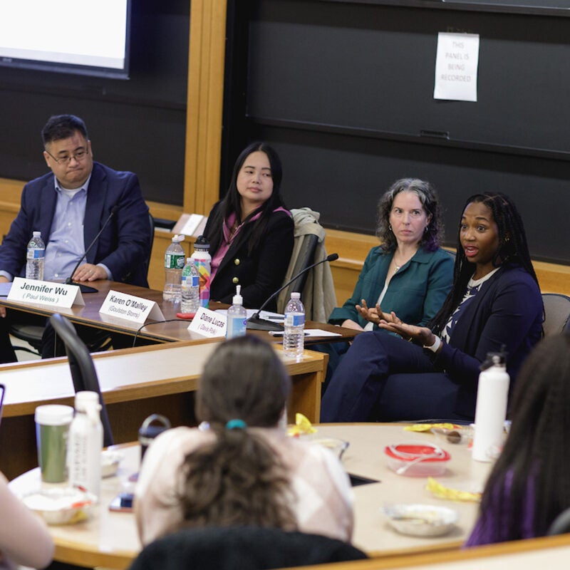 Four panelists speaking in a classroom setting