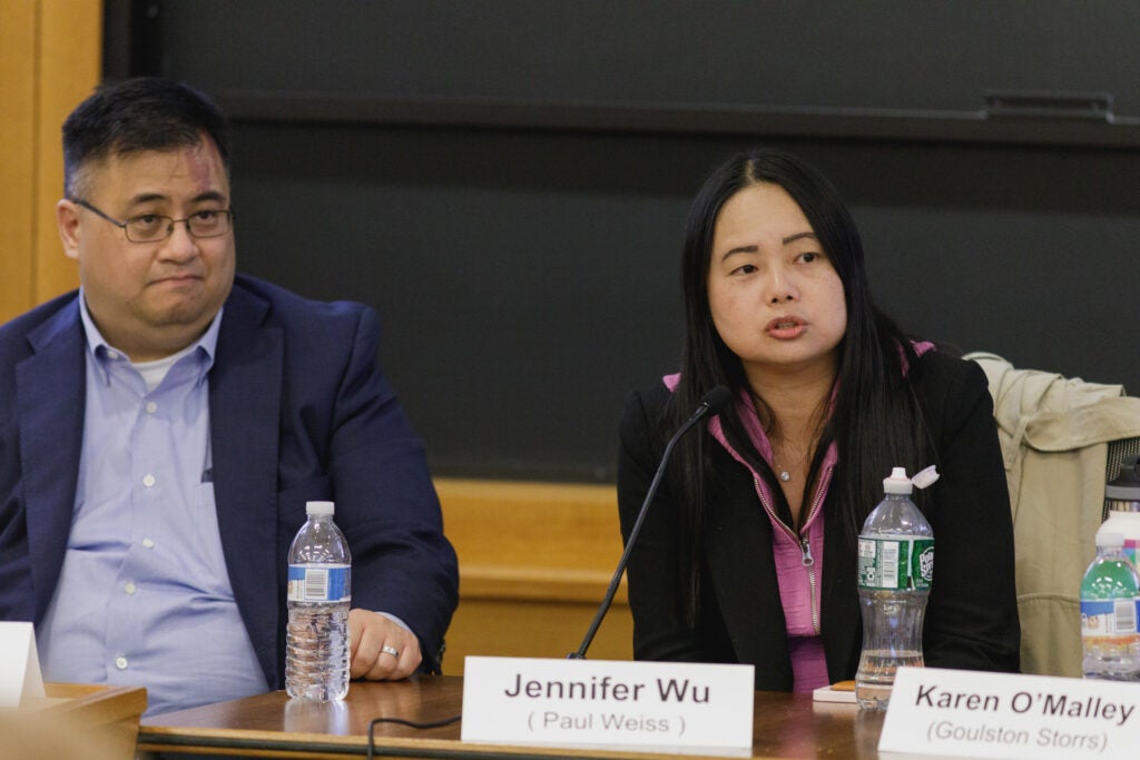 Wee sitting next to Wu as she speaks during the panel