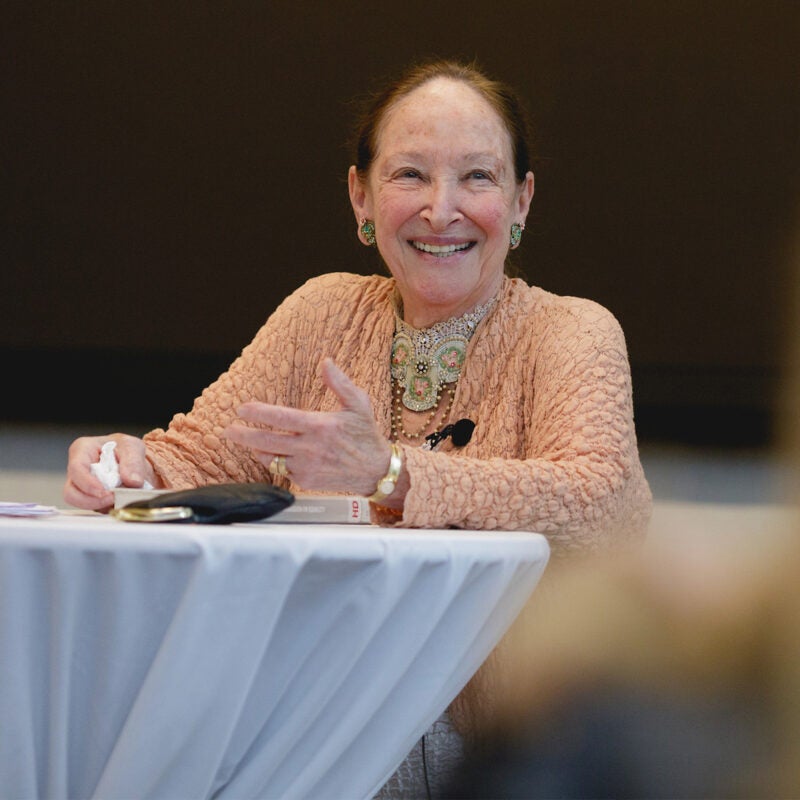 Rosalie Abella stands at a table speaking to an audience.