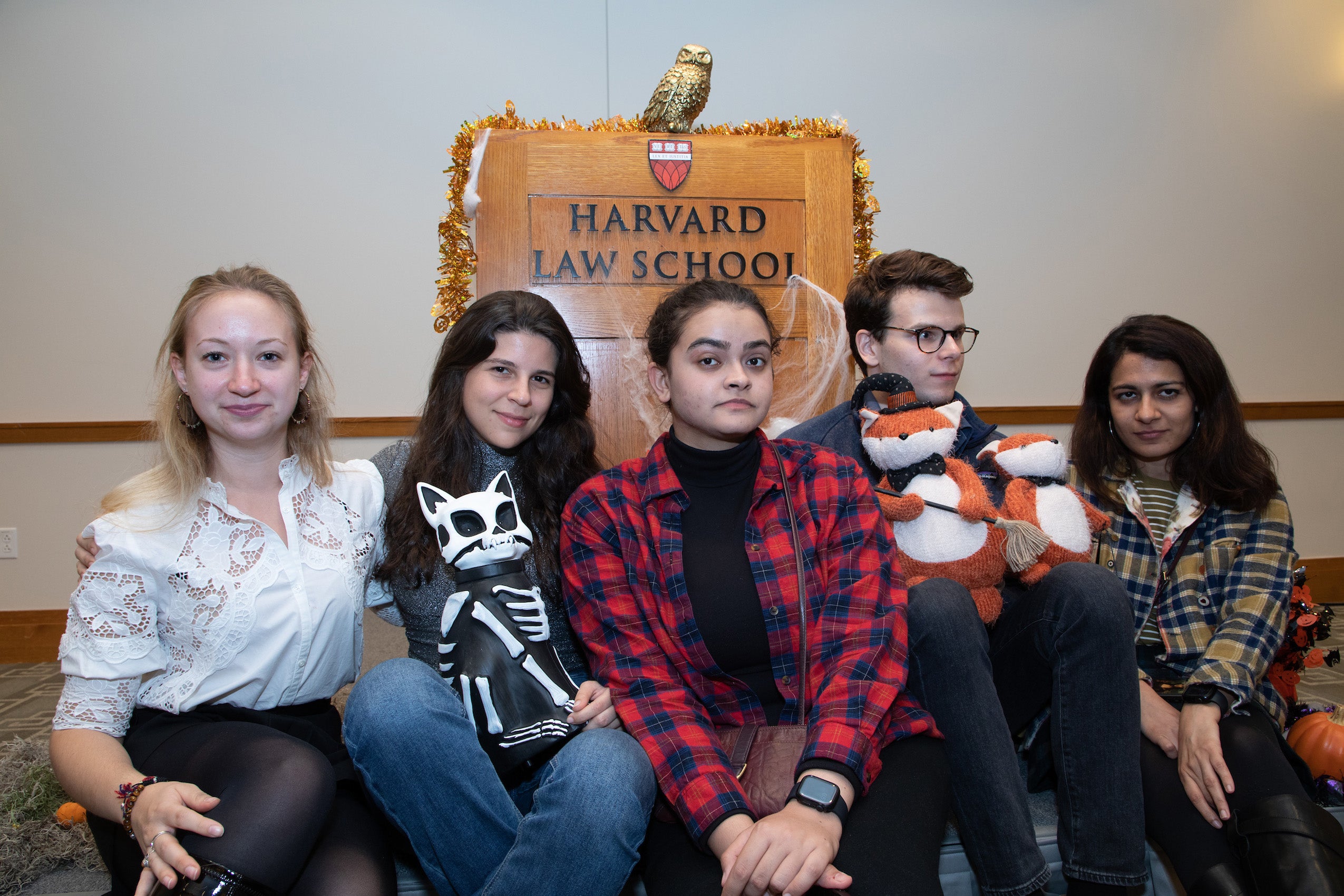 Six people sitting in front of an HLS podium
