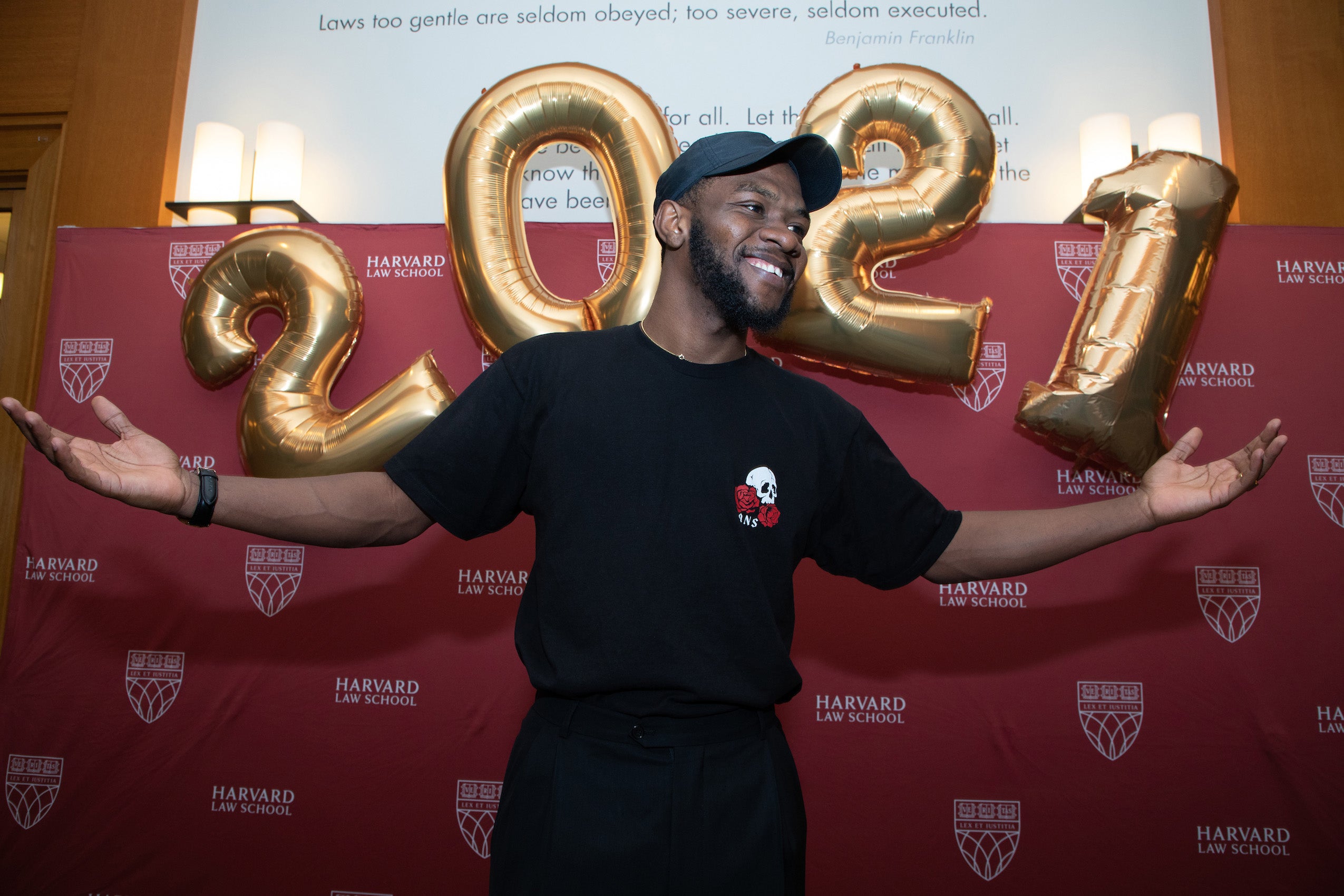 A man in front of a 2021 balloon
