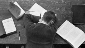 Student asleep on his books in the library