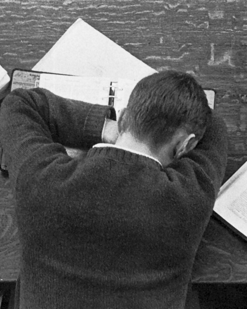 Student asleep on his books in the library