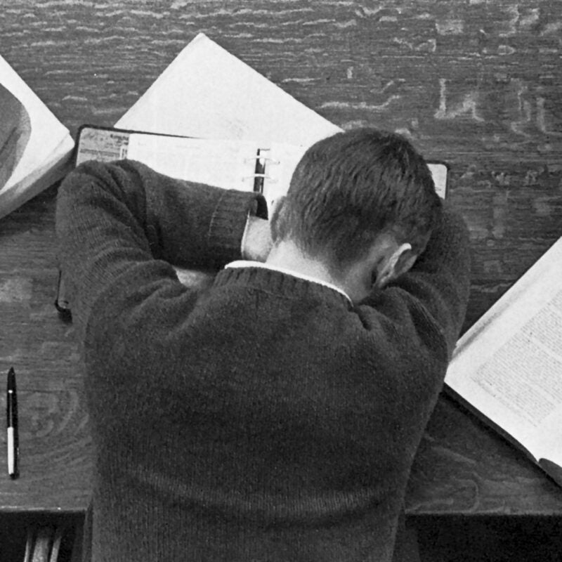 Student asleep on his books in the library