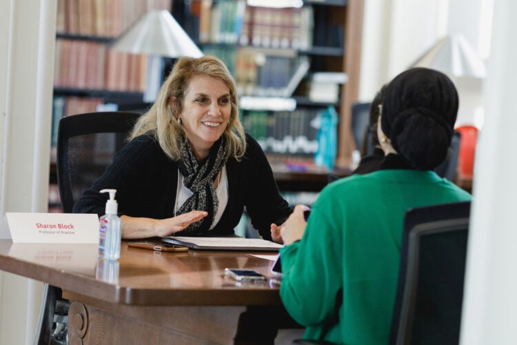Sharon Block speaks with a student.