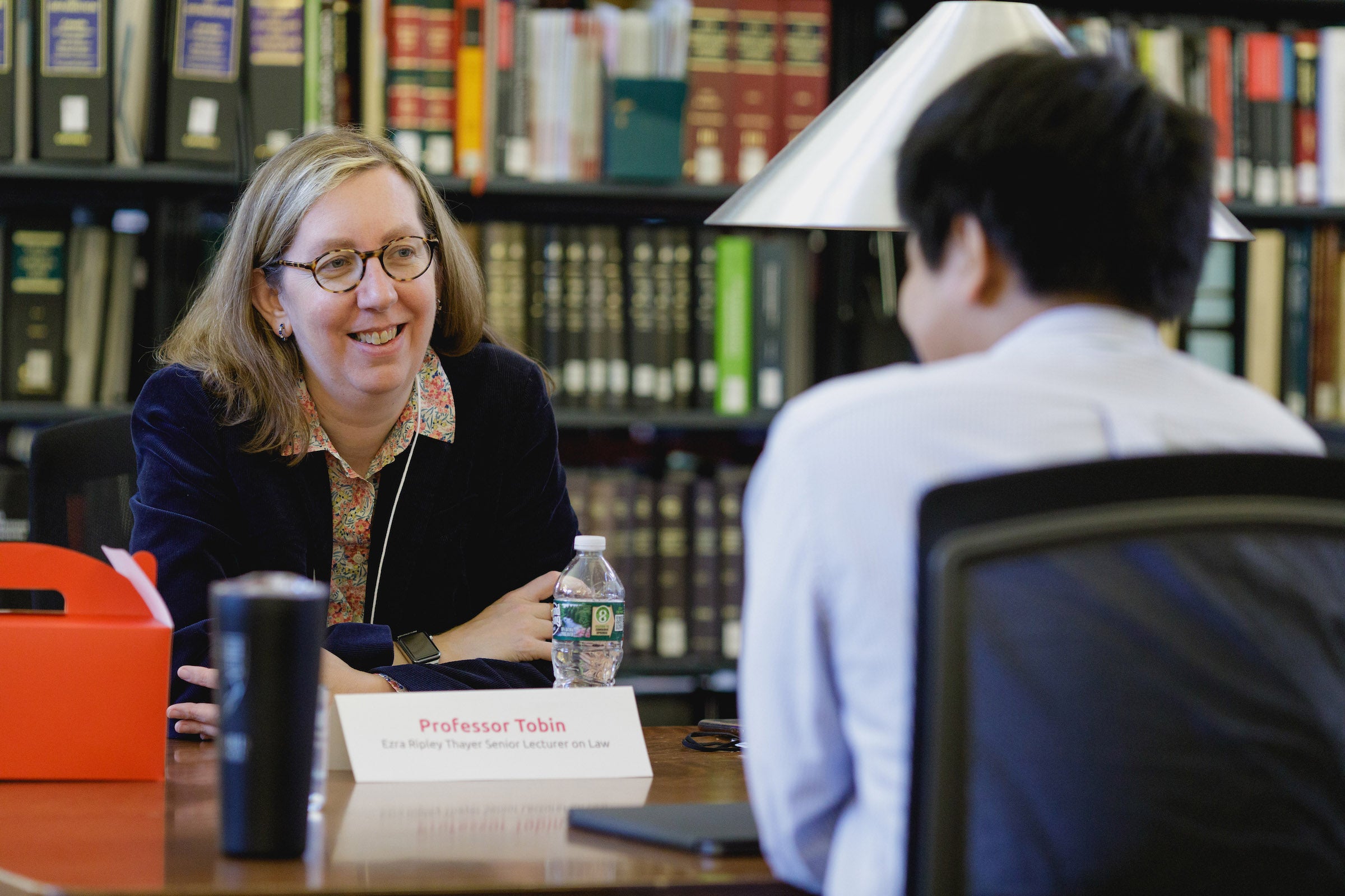 Susannah Barton Tobin speaking with a student.