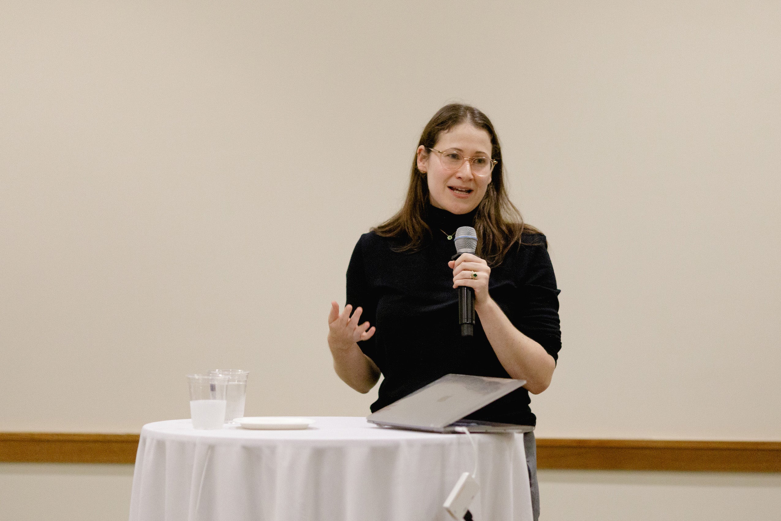 Woman speaking holding a microphone