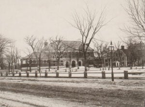 1883: The house to the right of Austin Hall was torn down in 1884. As a student, Oliver Wendell Holmes Jr. LL.B. 1866 had likely lived there. It’s where his father grew up.