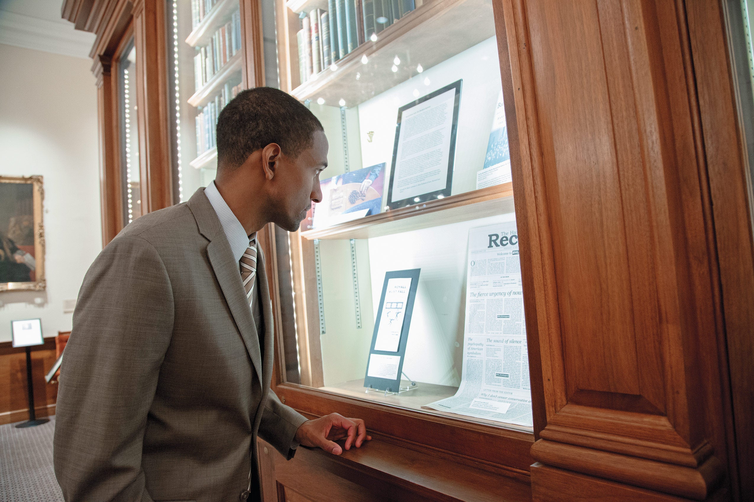 CBA participant Voltaire Sterling ’05 looks at an exhibit on the former HLS shield