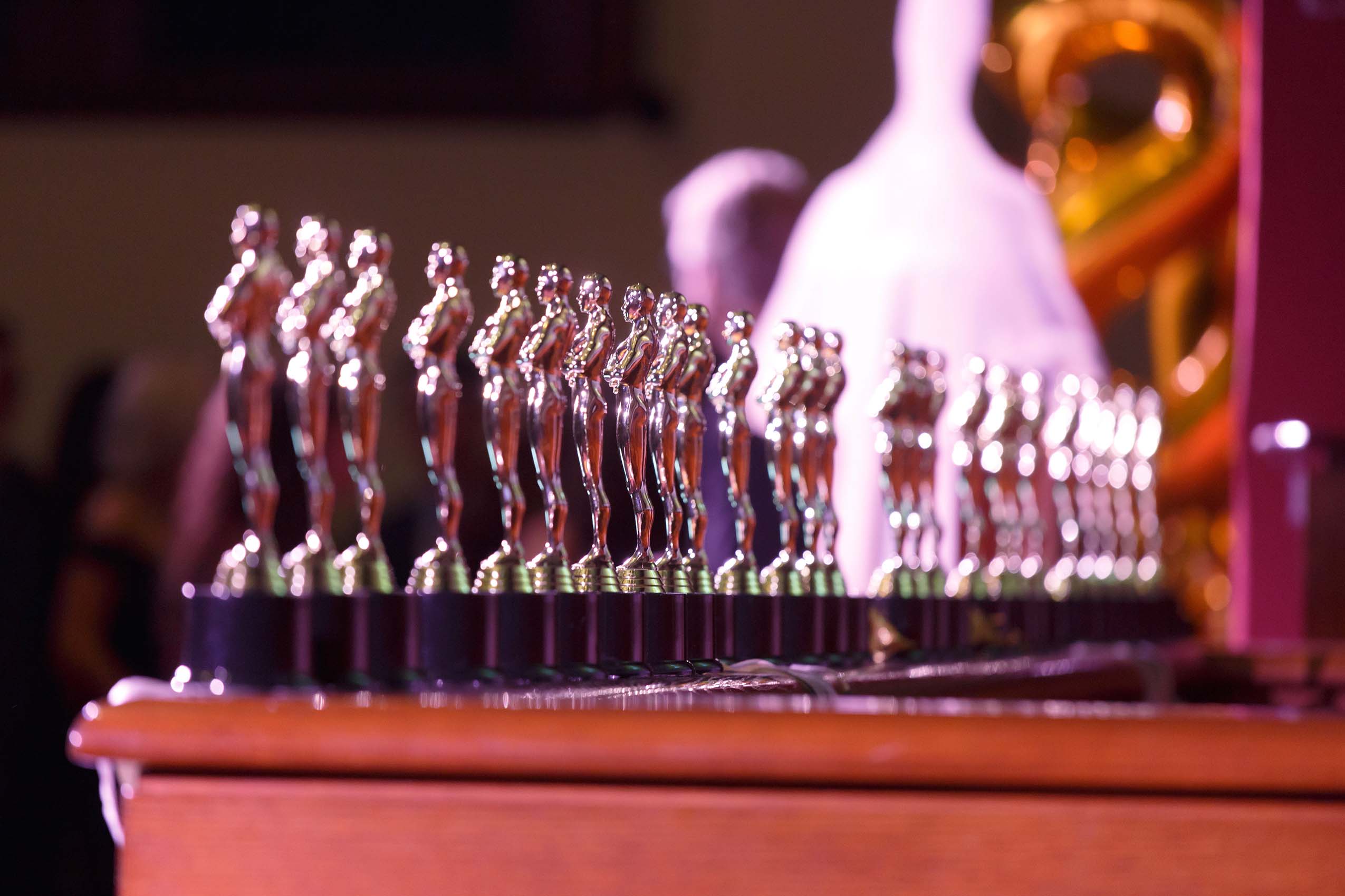 A row of golden statues resting on a ledge.