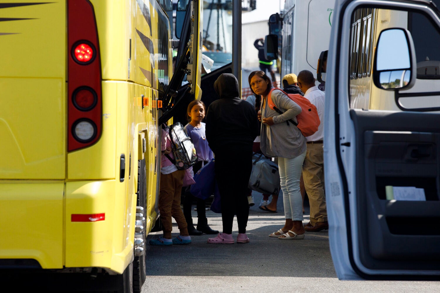 Venezuelan migrants await transportation at a ferry terminal.