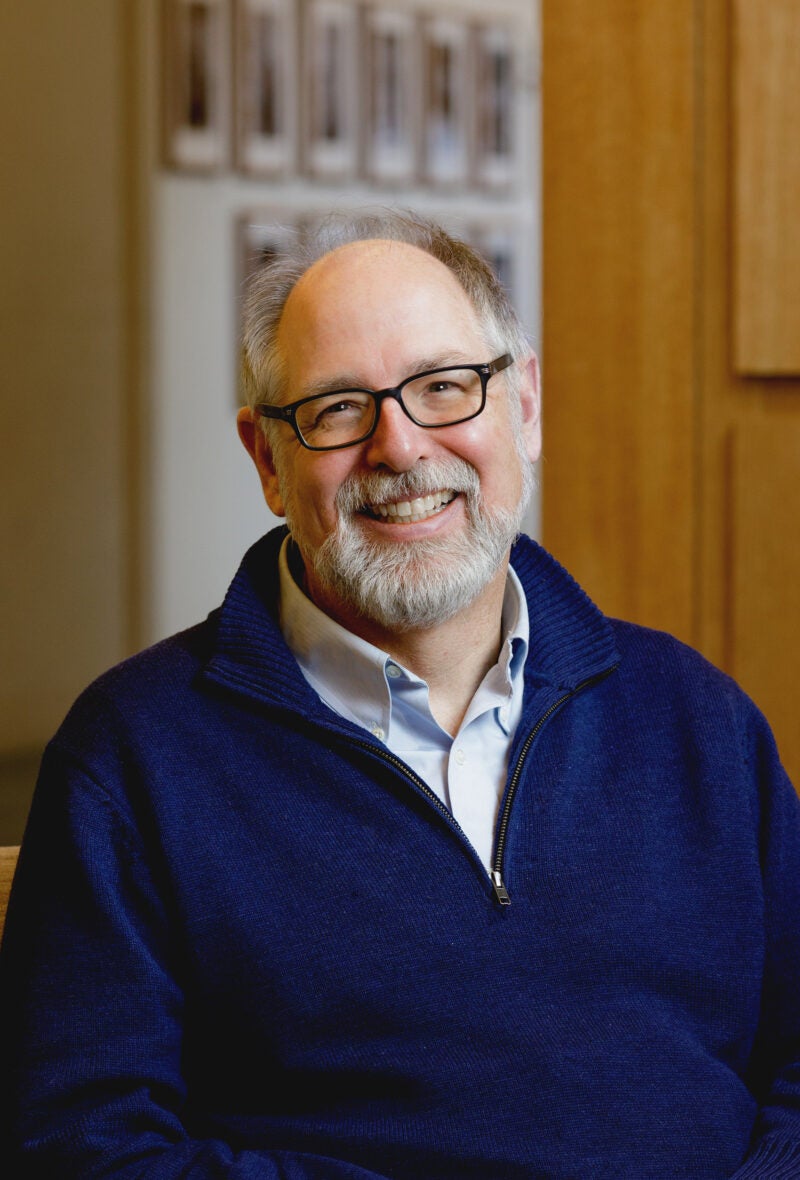 A man, Andrew Mergen, in a dark blue sweater.
