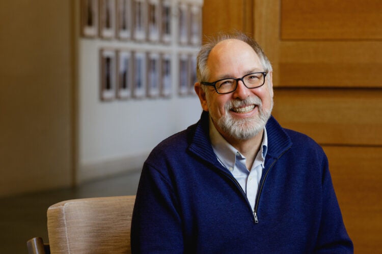 A man, Andrew Mergen, in a dark blue sweater.
