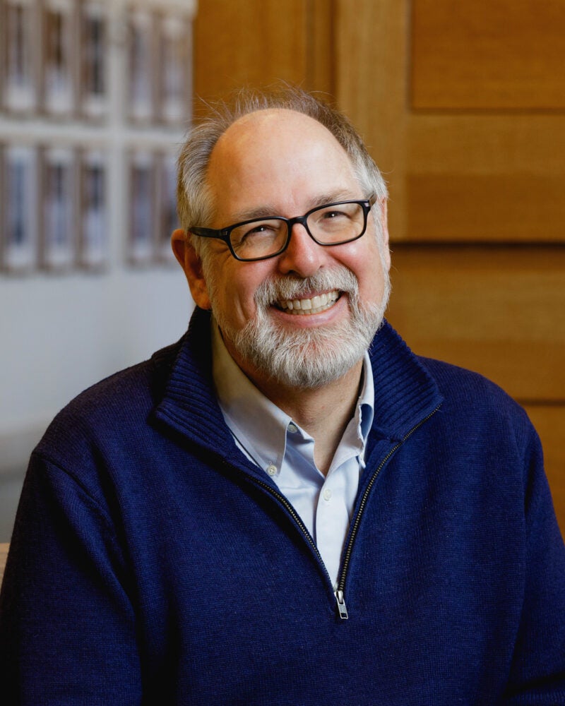 A man, Andrew Mergen, in a dark blue sweater.