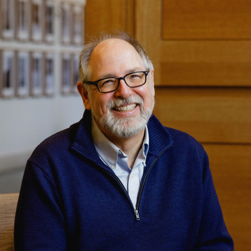 A man, Andrew Mergen, in a dark blue sweater.