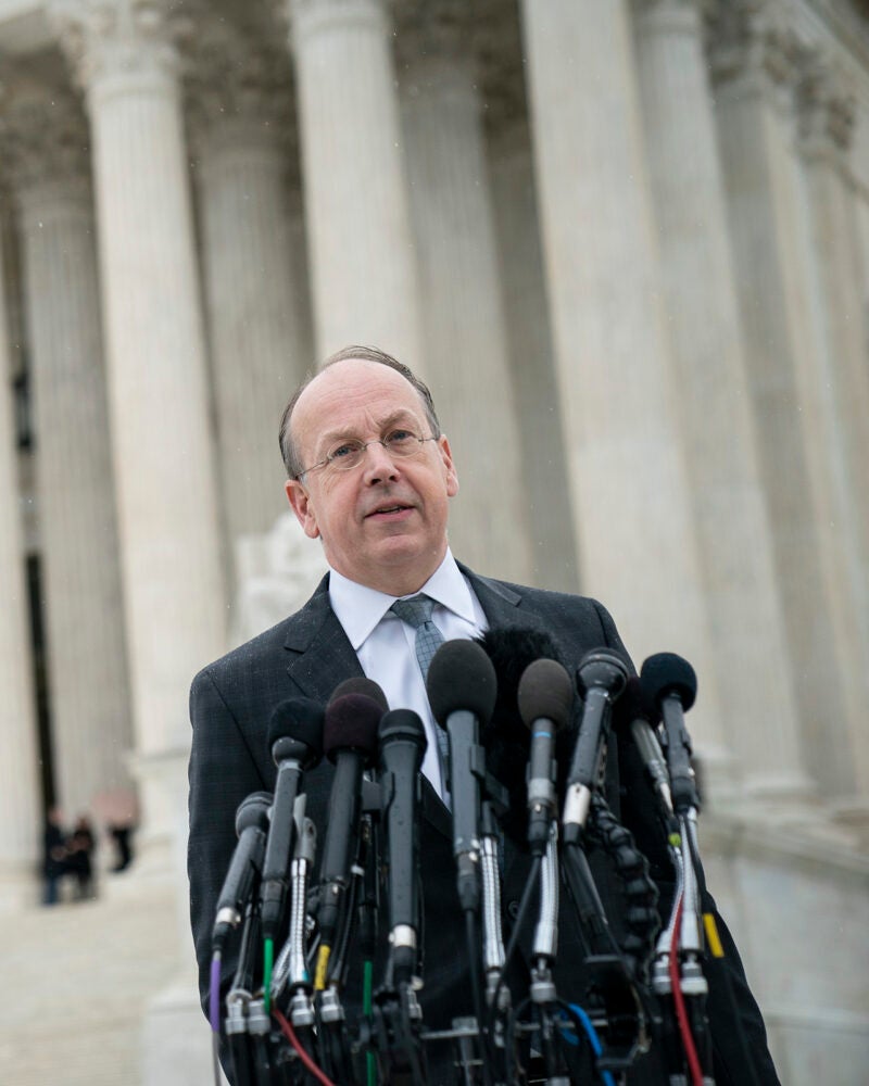 Paul Clement standing in front of the Supreme Court speaking to reporters.