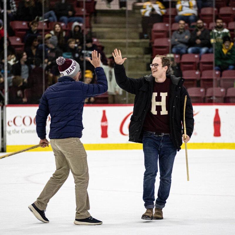 Two students participating in a shootout share a high five.