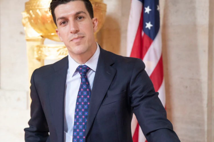 Man stands in front of American flag