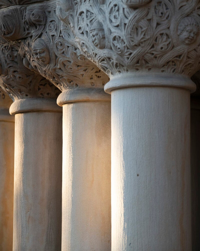 Close up of columns of a building bathed in early evening sun