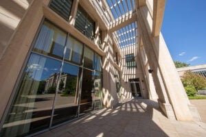 Side view of a campus building with another building reflected in its window