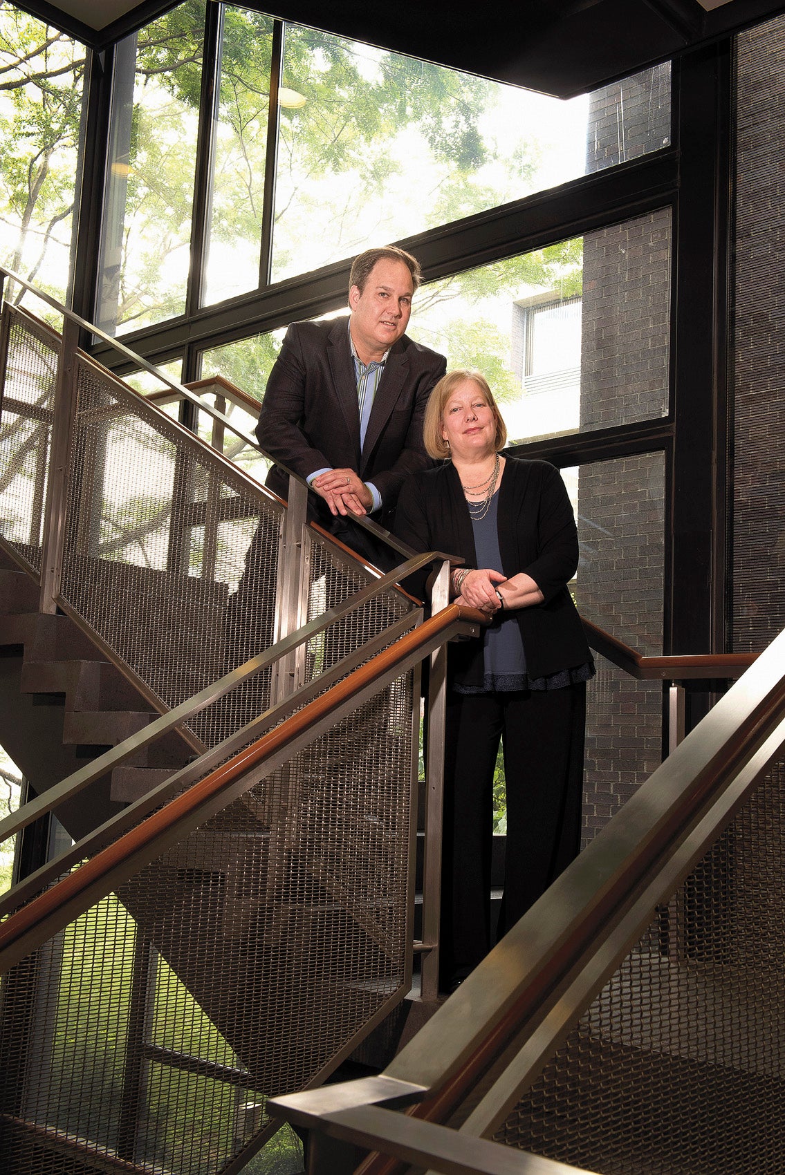 portrait of a man and a woman on a staircase on campus