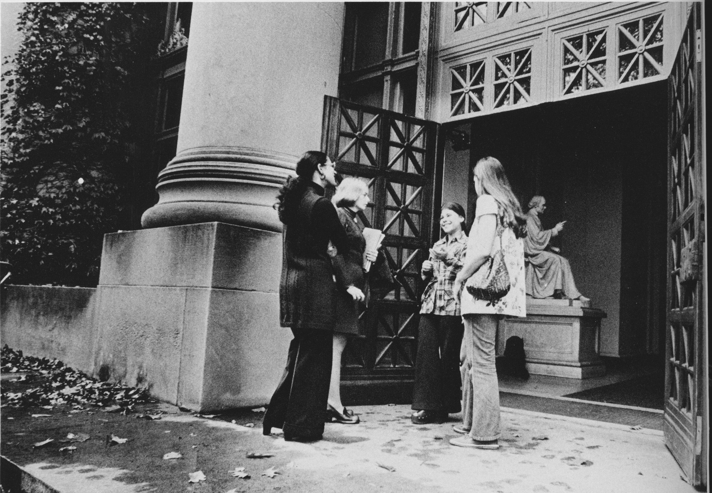 A group of women gather outside the main doors of Langdell Library on Harvard Law School's campus