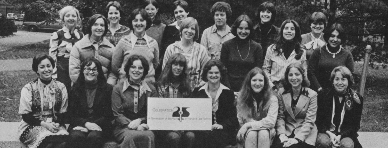 A group shot of 21 women holding a sign Celebration 25