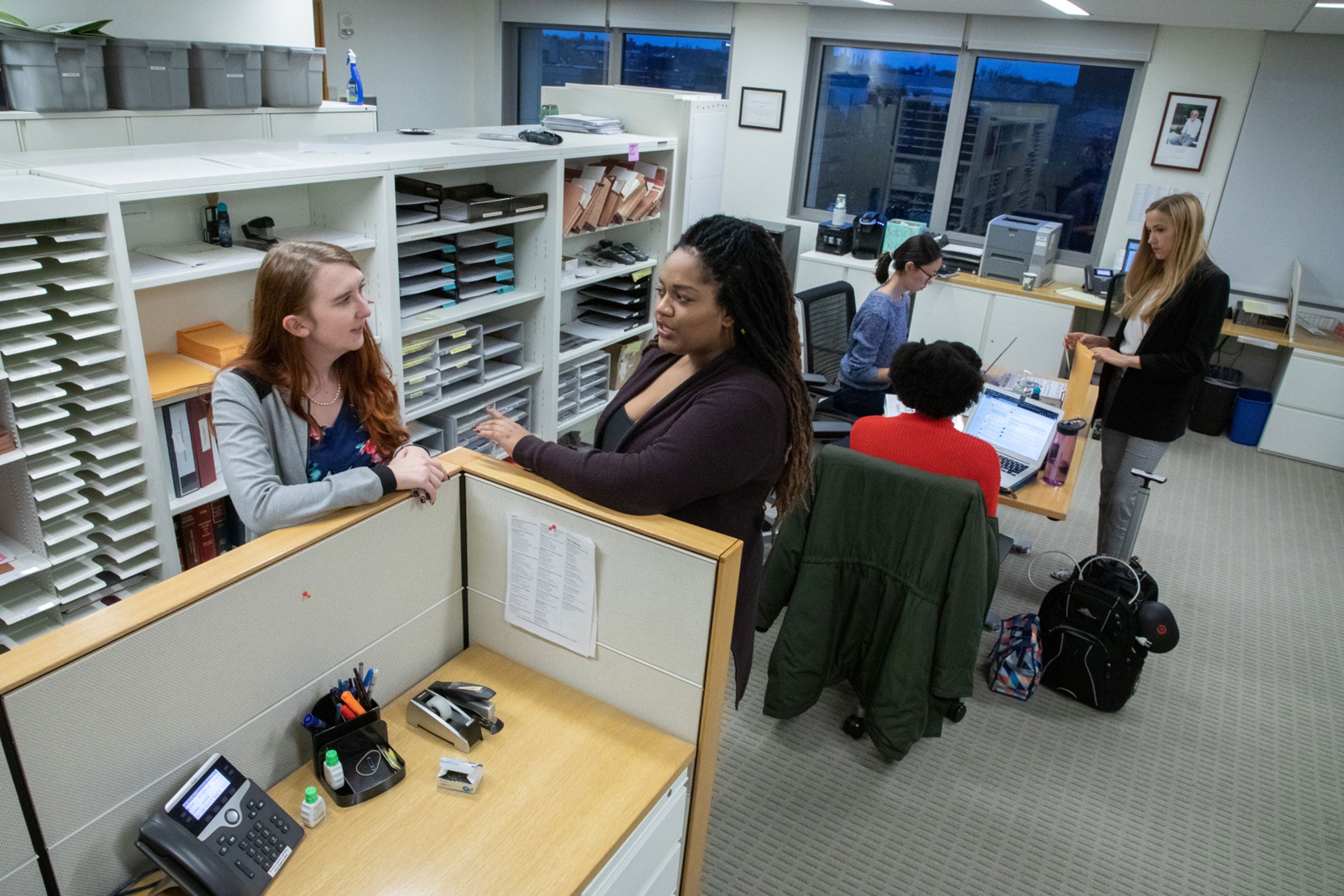 Women talking in small groups in a large room