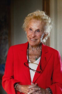 A portrait of a woman in a bright red blazer.