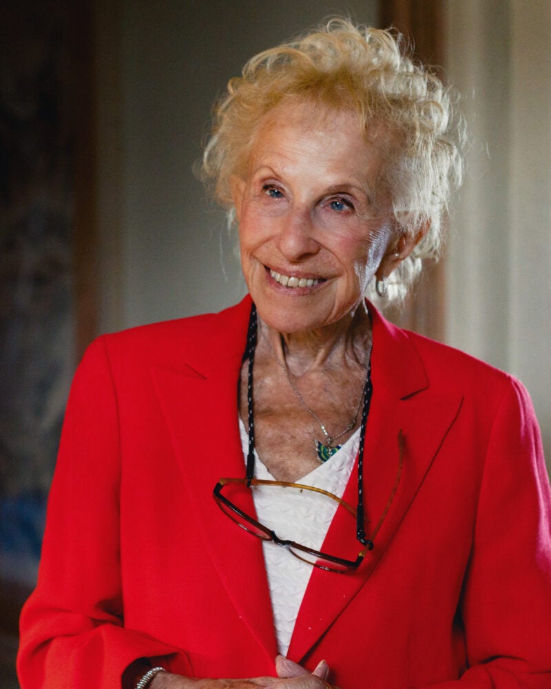 A portrait of a woman in a bright red blazer.