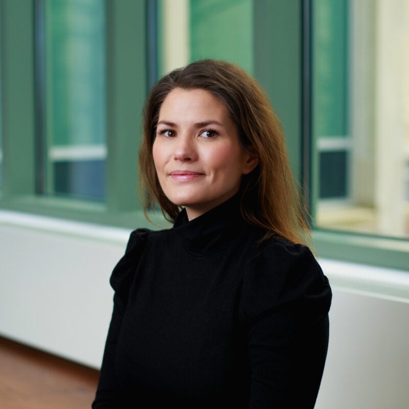 A portrait of a woman in a black shirt.