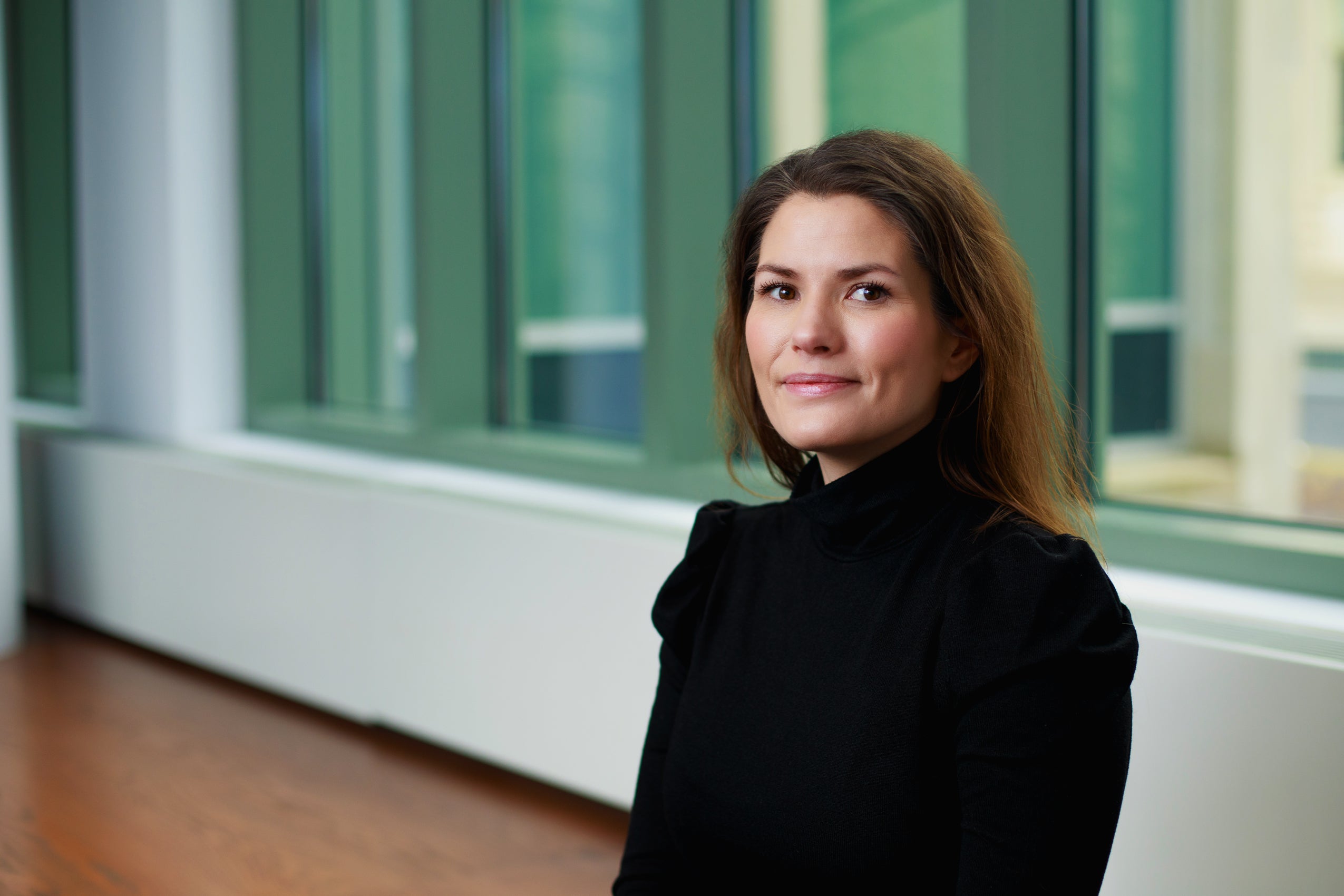 A portrait of a woman in a black shirt.