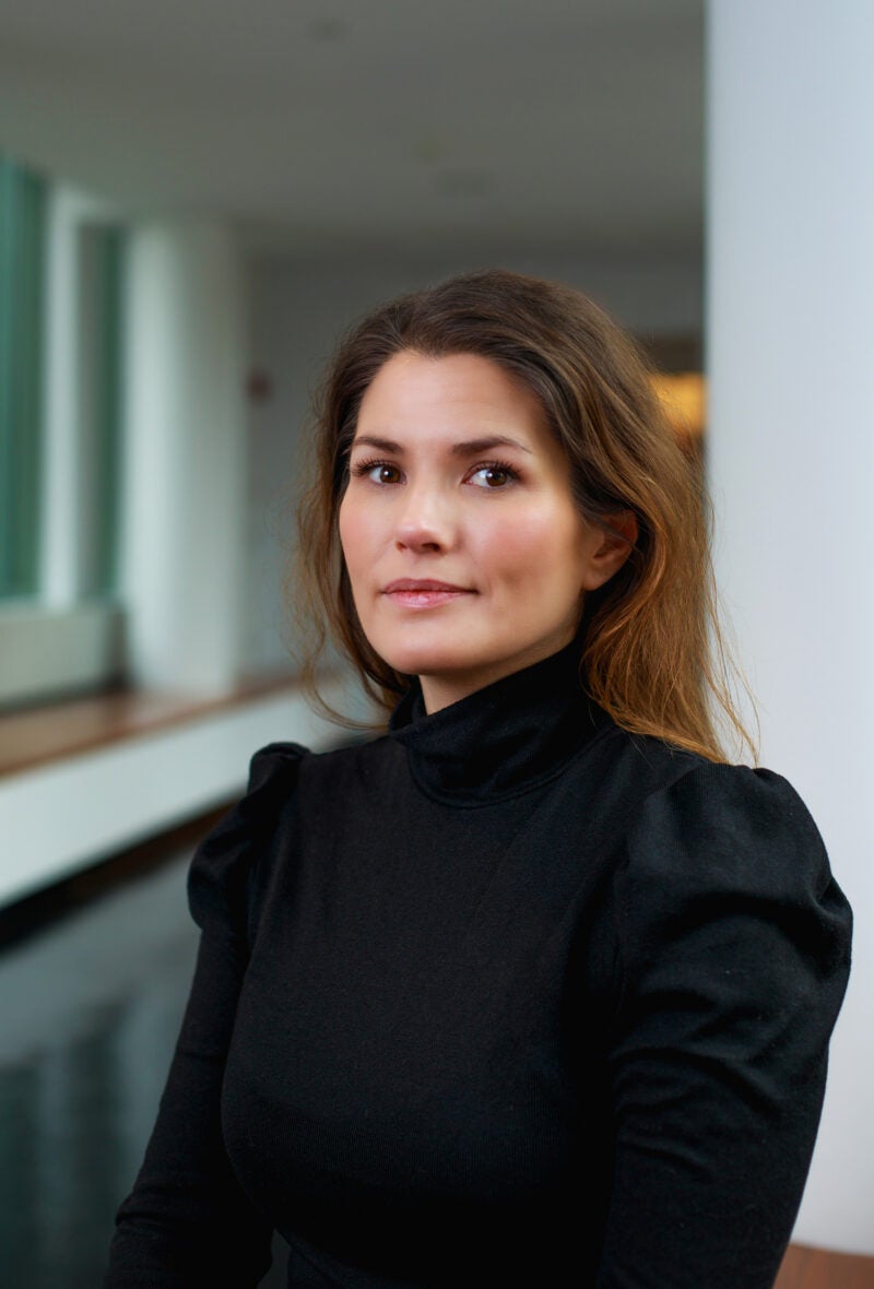 A portrait of a woman in a black shirt.