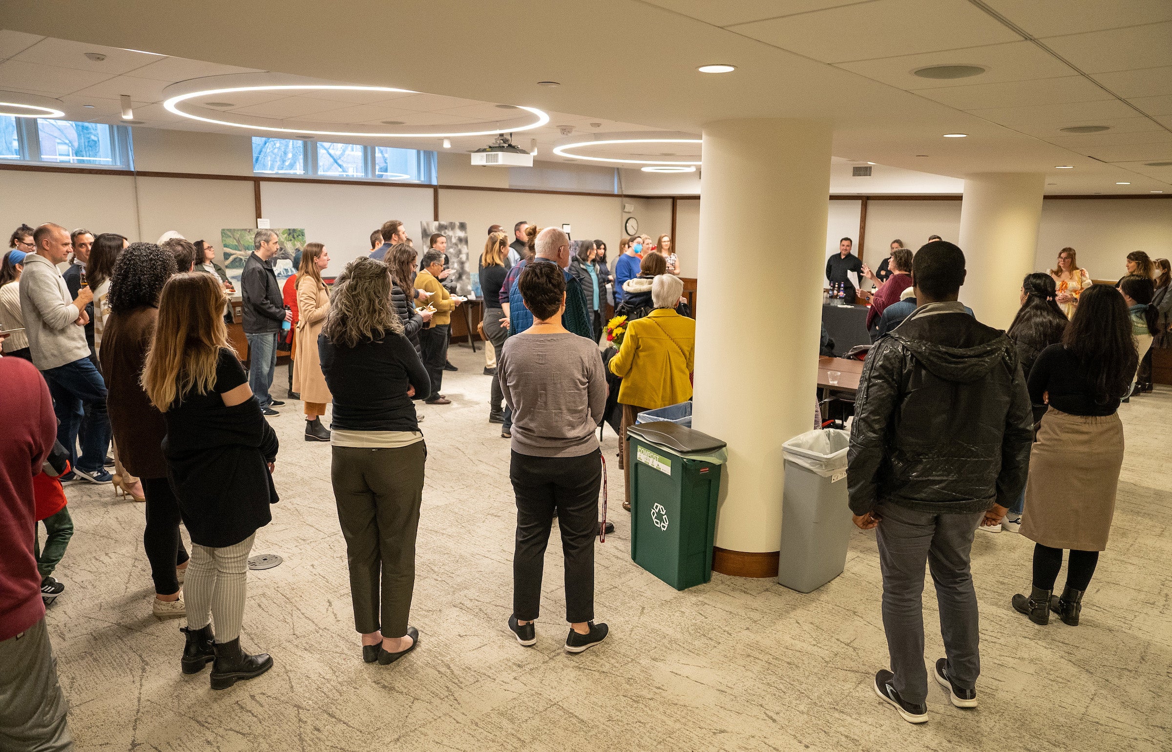 People listening to a presentation from an event organizer.