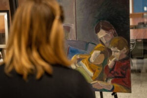 A person looking at a painting of three people