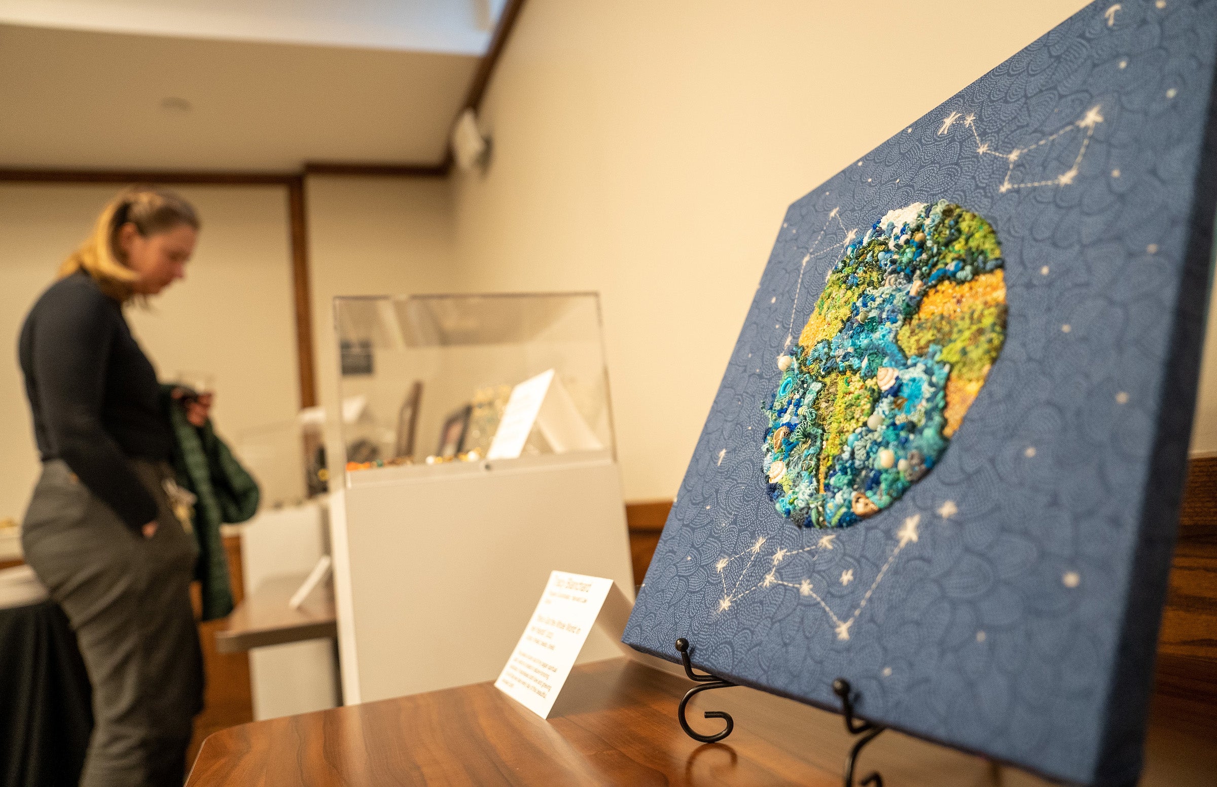 Embroidery art of the earth and sky with constellations.