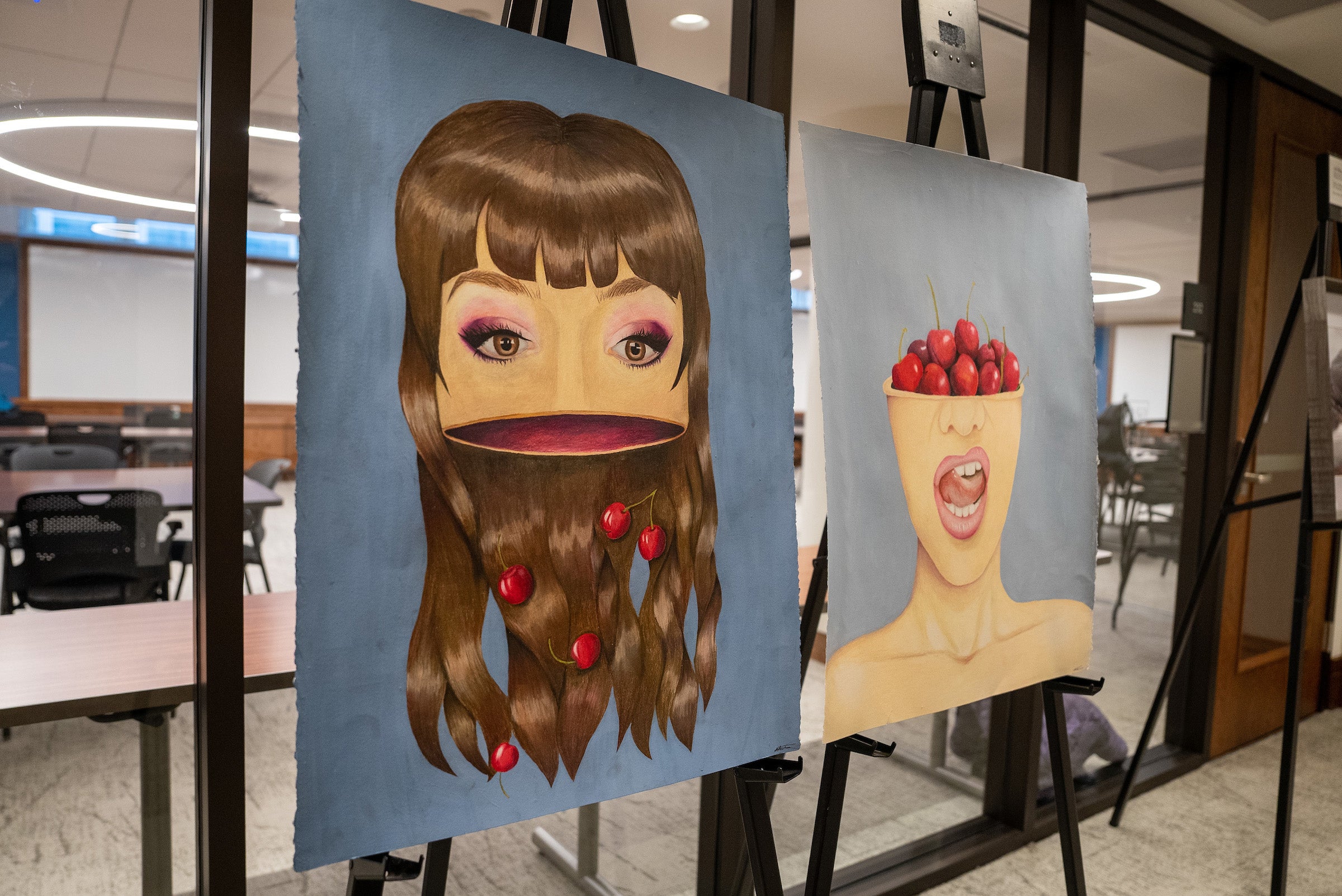 Abstract paintings of women's faces with cherries.