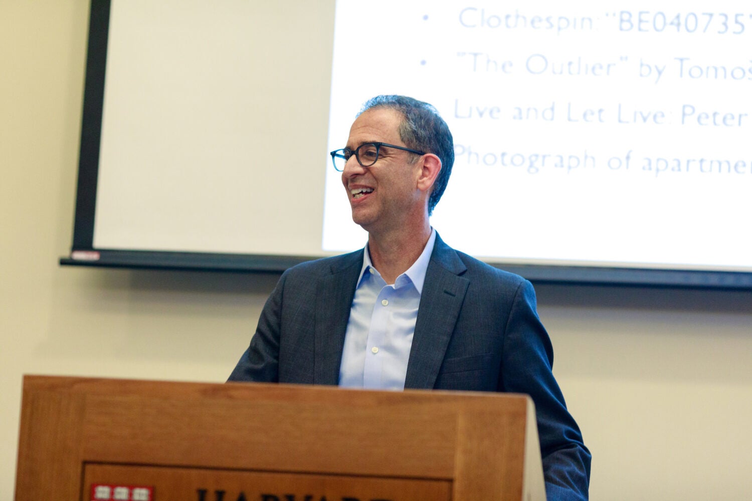 John Goldberg smiling from behind the podium.