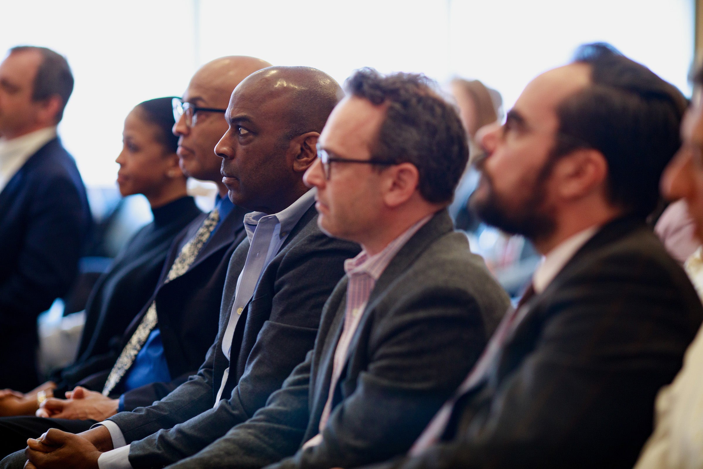 Audience members listening.