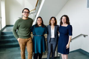 Skadden Fellows pose and smile in a hallway