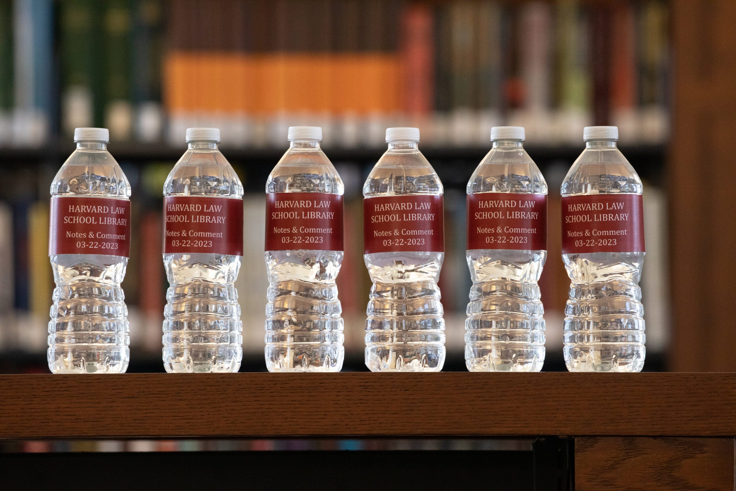 A row of bottled waters with the words Notes & Comment on the label