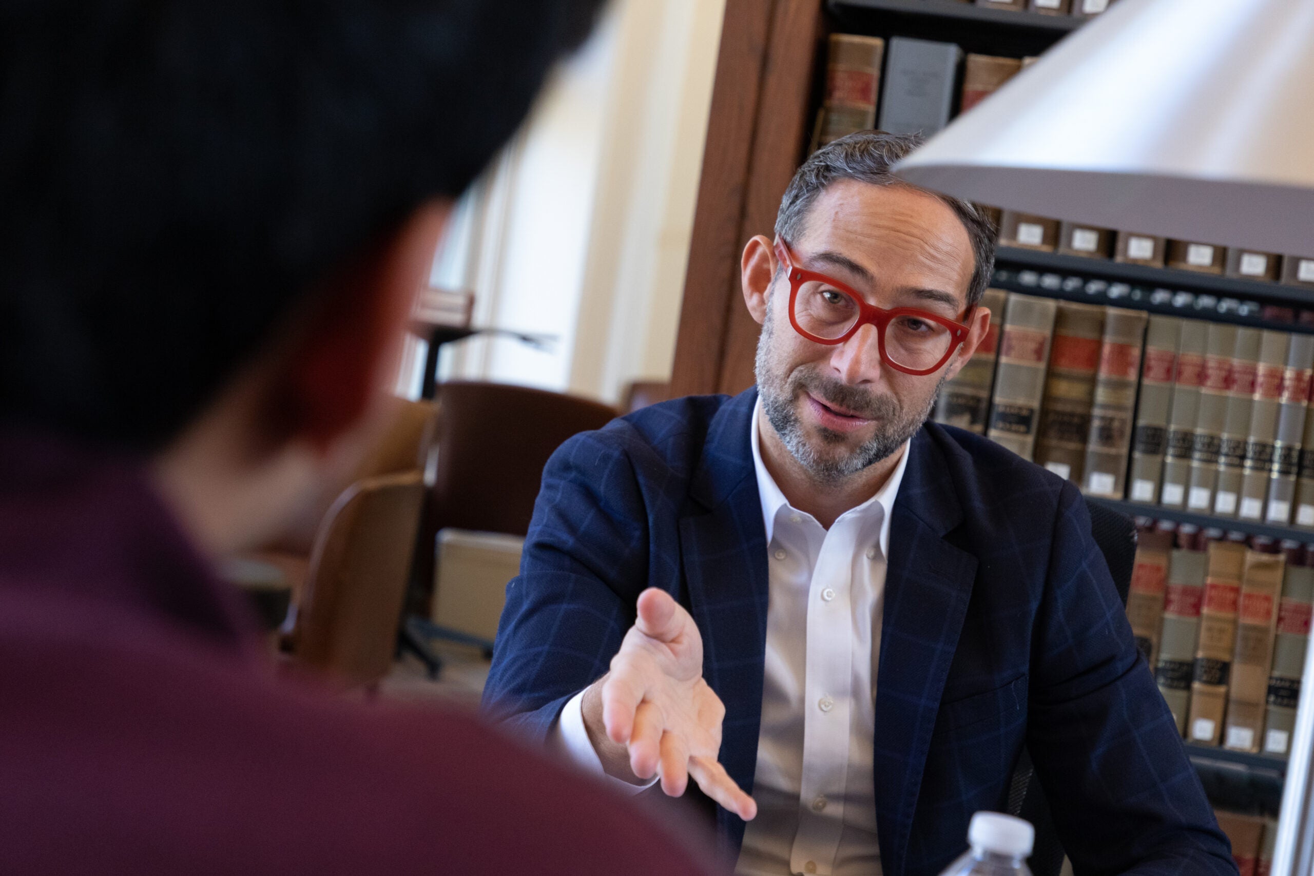 A close up of a man having a conversation in the library
